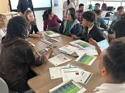 Students talking with Capgemini's Julia Lievre-Cormier during a working session at Tech 4 Sustainable Futures